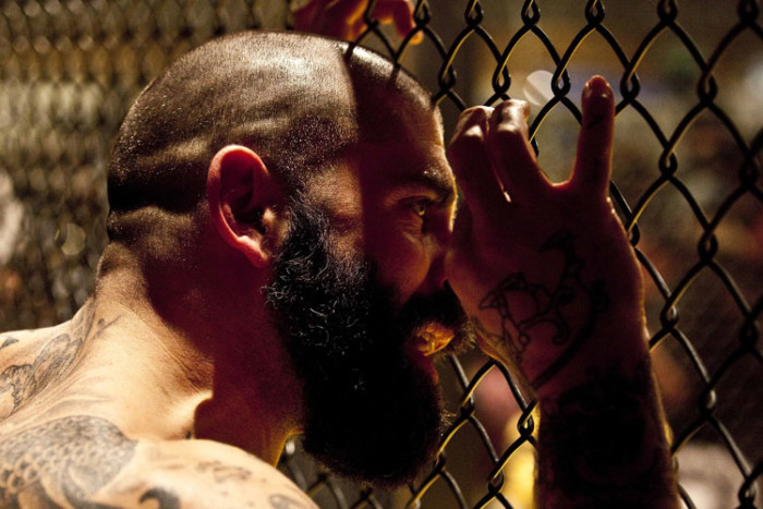 Side-profile of an MMA fighter with a military buzz cut highlighting facial features